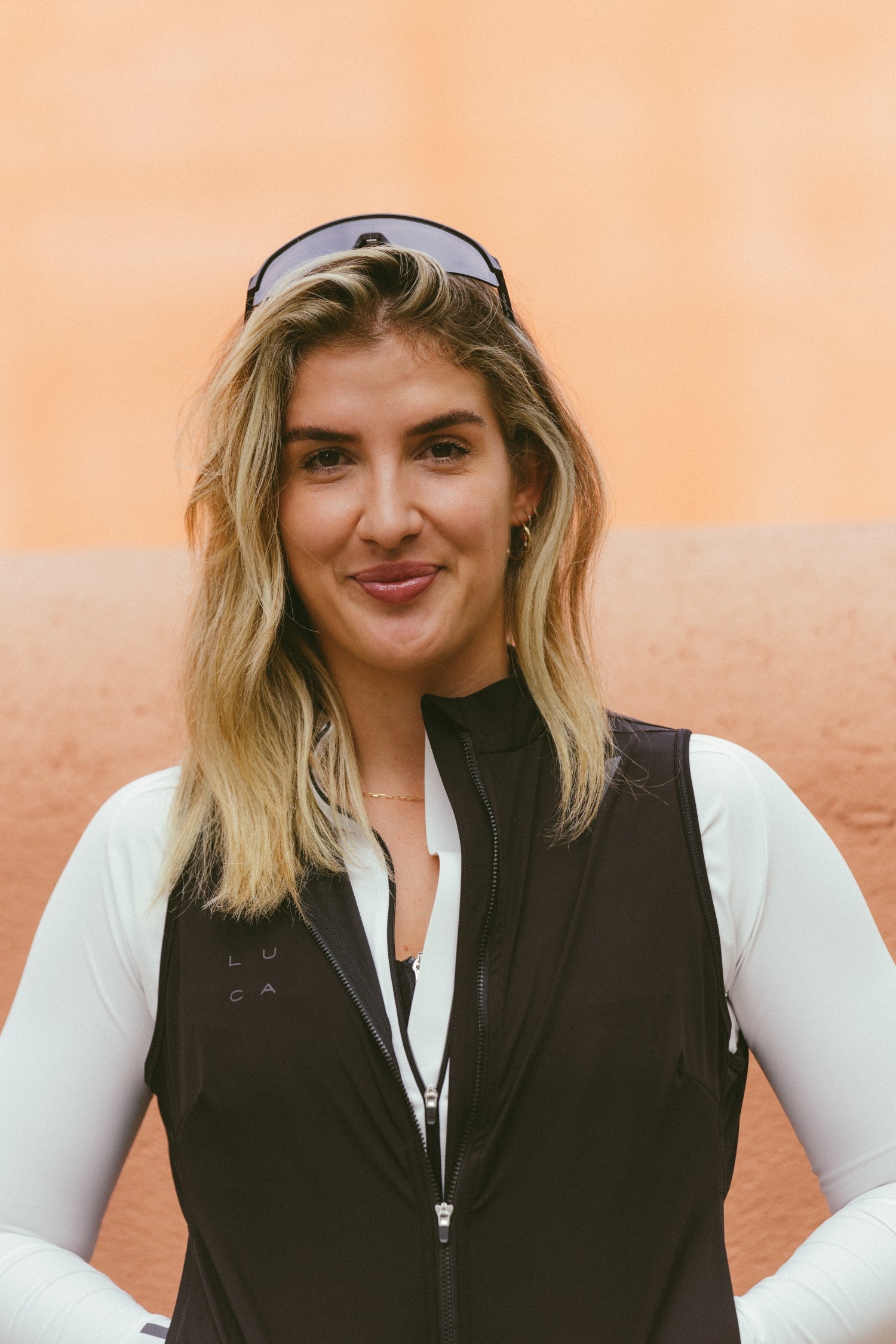 Close-up-portrait-of-a-female-cyclist-smiling-wearing-a-black-LUCA-gilet.