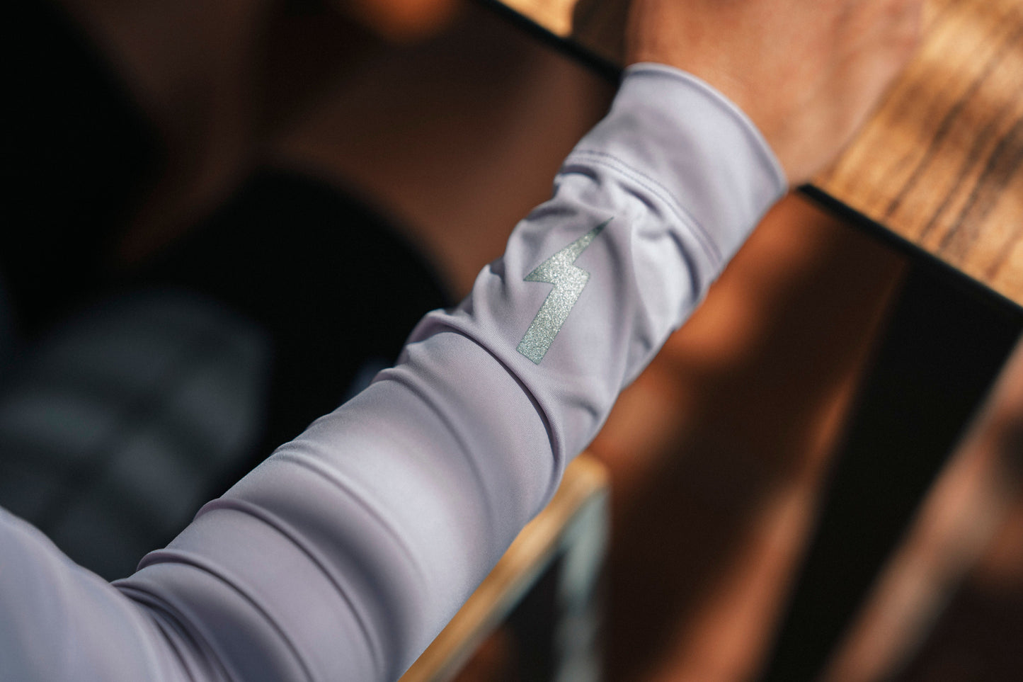 Close-up-shot-of-the-sleeve-of-a-light-lilac-showing-the-fabric-and-arm-fit-with-a-blurred-background