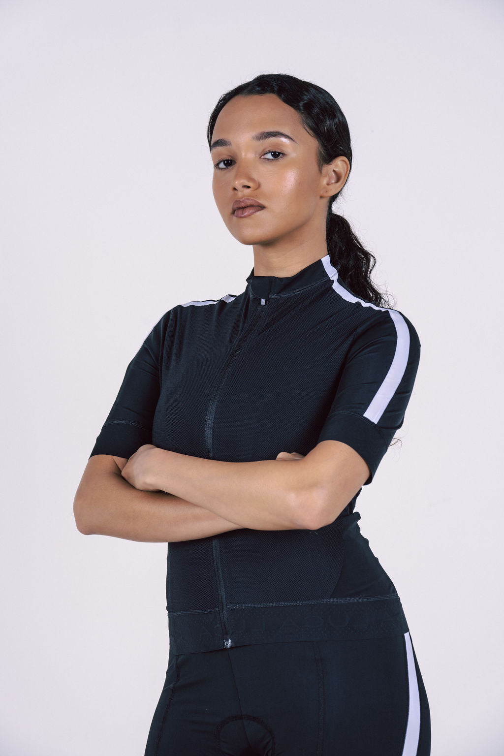 Black-cycling-jersey-with-front-zip- and-white-side-stripes-on-the-sleeves-and-shoulder-worn-by-a- model