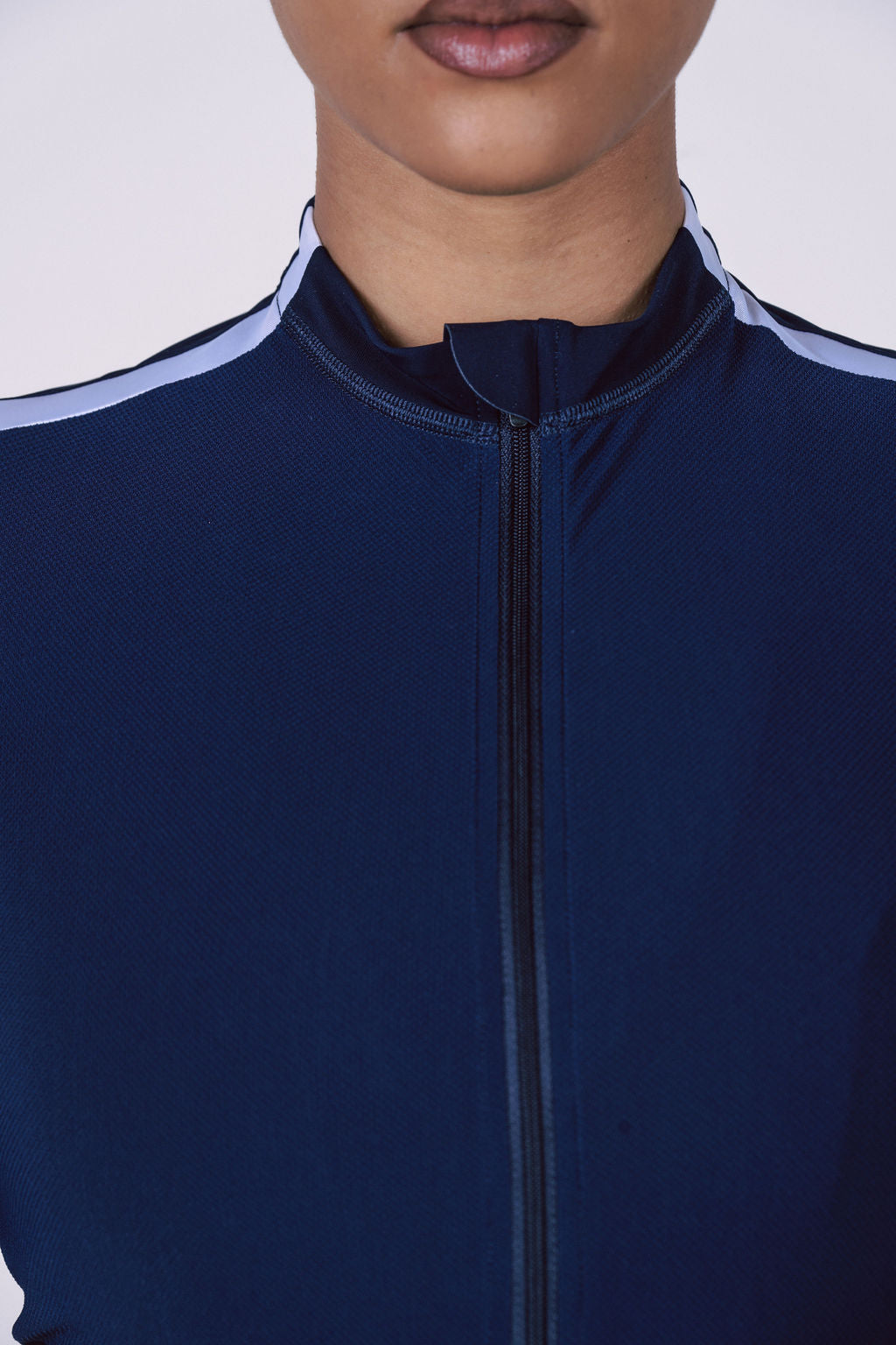 Detail-of-a-navy-blue-long-sleeve- cycling-top-with-white-reflective- stripe-over-the-shoulder