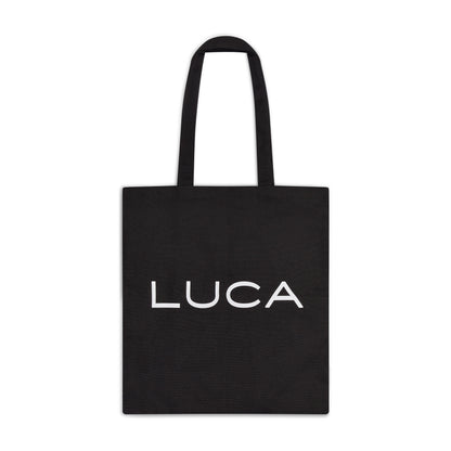 Black-cotton-canvas-tote-bag-with- white-LUCA-logo-printed-on-the- front-with-shoulder-straps-on-a- white-background